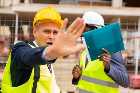 Engineers hiding their faces in front of camera Stock Photos