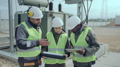 Engineers hold folder and tablet discussing station project Video stock 142968119