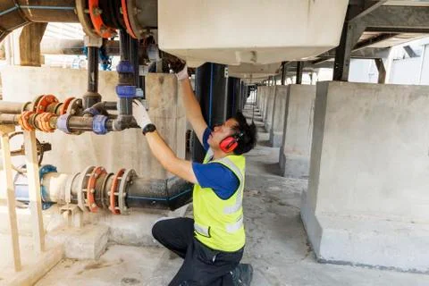 Engineers inspect machine operations. Cooling tower in a large building That  Stock Photos