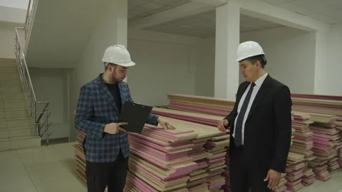 Engineers Inspecting Construction Materials in Warehouse 库存影片 345100128