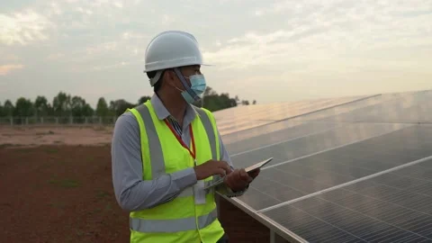 Engineers inspecting solar panels for solar power generation Stock Footage 173365669