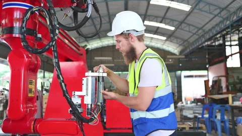 An engineers installing and testing a large robotic arm. Stock Footage 254550856