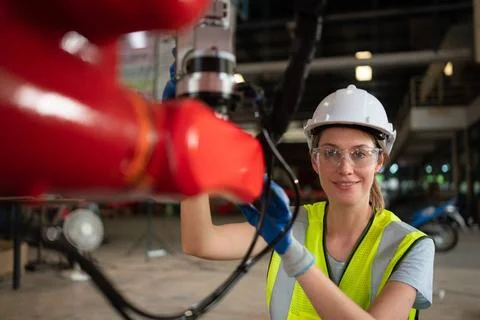An engineers installing and testing a large robotic arm. before sending it... 写真素材