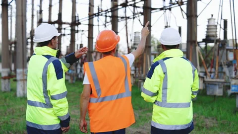 Engineers looks at the construction of high-voltage power. Teams engineer Stock Footage 194618757