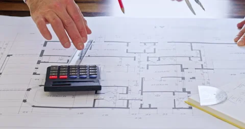 Engineers make calculations about project using calculator Stock Footage 243830202