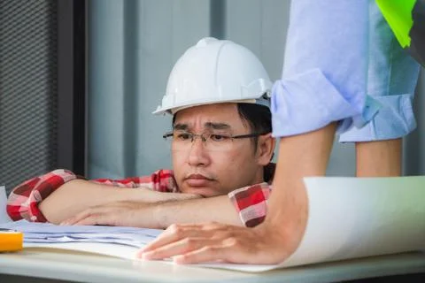 Engineers man looking at documents, partners group meeting at construction site Stock Photos