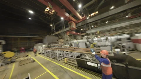 Engineers maneuver large iron beam locking into place in workshop Stock Footage 304412787