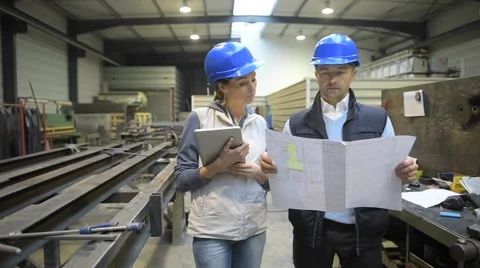 Engineers in mechanical factory reading instructions Stock Footage 46731366
