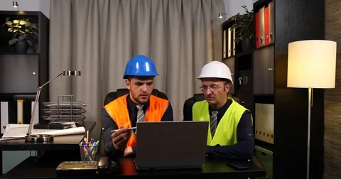 Engineers Men Team Work Collaboration Examining Digital Blueprint Plan on Laptop Stock Footage 77005813