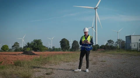 Engineers men working at wind turbine farm. Video stock 228994453