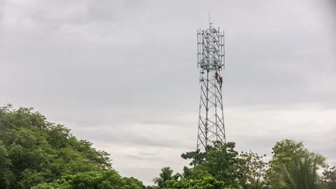 Engineers mount a telecommunication tower for 5G equipment. Stock Footage 159497701