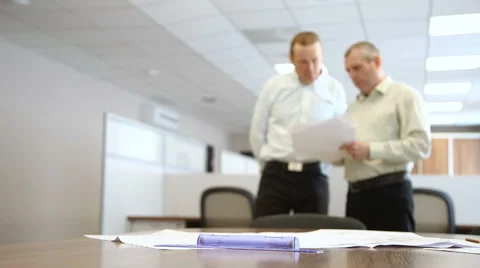 Engineers in the office to discuss the documents on the background of the table Stock Footage 63132196