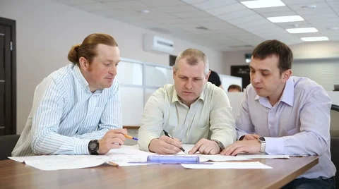 Engineers in the office discussing a new project Stock Footage 62976779
