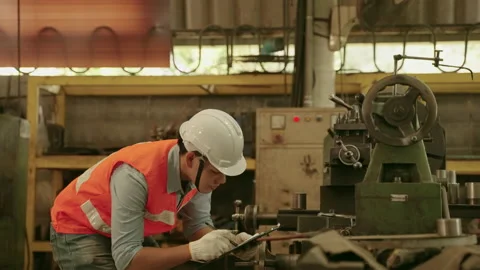 Engineers or inspectors checking the machines in the factory Stock Footage 153863087