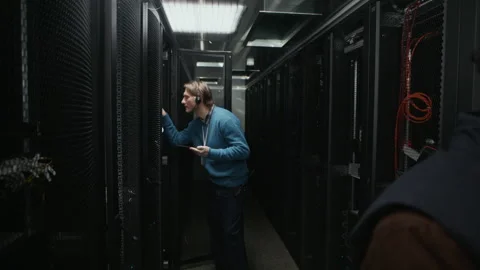 Engineers Performing Server Rack Maintenance in Data Center Stock Footage 330544351