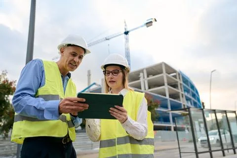 Engineers planning construction project using digital tablet Stock Photos