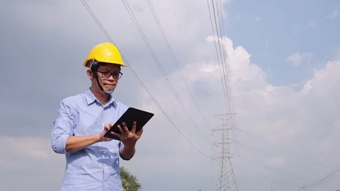 Engineers at the power plant with tablets in hand, work diligently. Slow motion Stock Footage 118210935