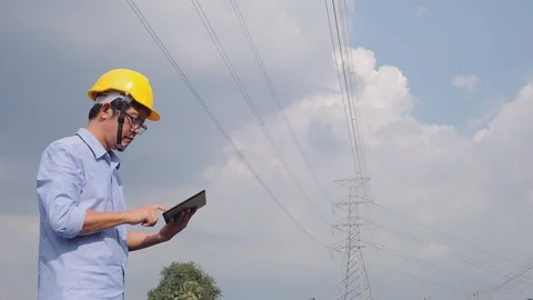 Engineers at the power plant with tablets in hand, work diligently Stock Footage 118211067