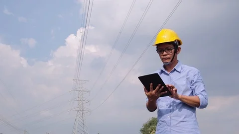 Engineers at the power plant with tablets in hand, work diligently. Slow motion Stock Footage 118211127
