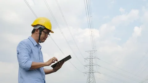 Engineers at the power plant with tablets in hand, work diligently Stock Footage 118973402