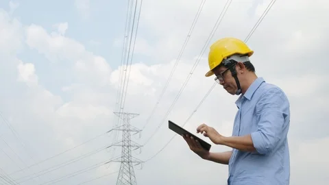 Engineers at the power plant with tablets in hand, work diligently Stock Footage 118973462