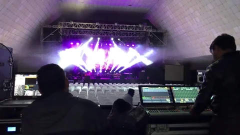 Engineers preparing lighting and video projections at empty venue before a show Stock Footage 83254727