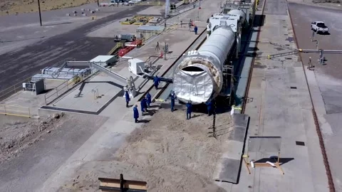 Engineers removing protective cover from rocket booster prior to hot fire test Stock Footage 281724172