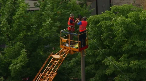 Engineers repairing lighting a lantern on a pole. Real time. Stock Footage 65266460