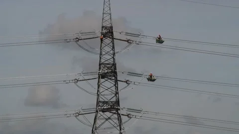Engineers replacing high tension electricity cables united kingdom Stock Footage 213302932