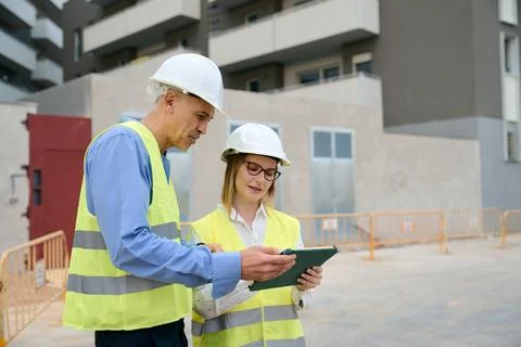 Engineers reviewing construction plans on tablet Stock Photos