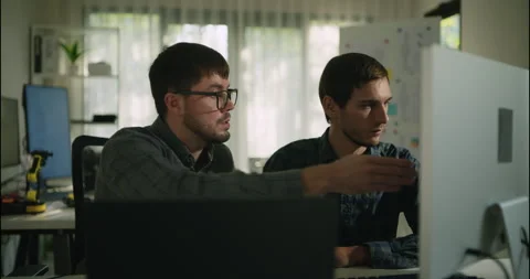 Engineers Reviewing Robotics Code on Screen Together. Stock Footage 306737731