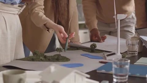 Engineers Reviewing Wind Turbine Models for Renewable Project Stock Footage 320090917
