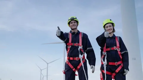 Engineers in safety gear working at height are standing with thumb up Stock Footage 166312963