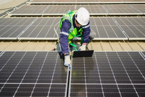 Engineers with safety helmet checking solar system at solar power farm Stock Photos