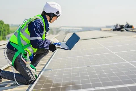 Engineers with safety helmet checking solar system at solar power farm Stock Photos