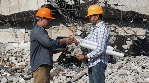 Engineers shaking hands on demolish building. Stock Footage 110507490