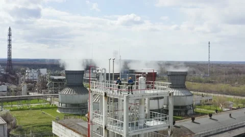 Engineers stand on the large industrial building. Industrial pipes of plant Stock Footage 170146409