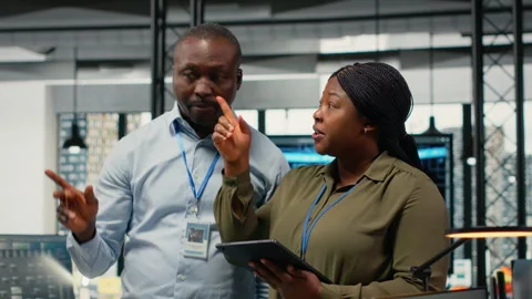 Engineers in startup office work with artificial intelligence driving innovation Stock Footage 323238865