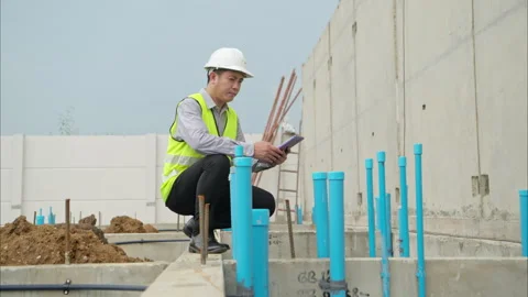 Engineers supervise construction work and inspect the foundation work 스톡 동영상 309938309