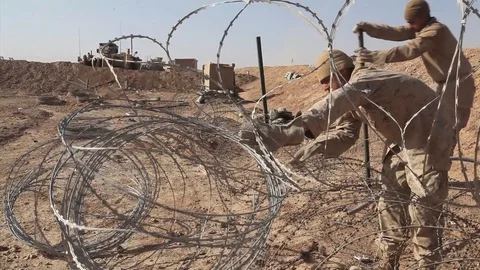 Engineers take down concertina wire in order to make way for Hesco barriers-2010 Stock Footage 107544517