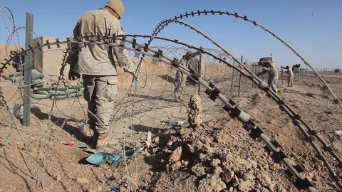 Engineers take down concertina wire in order to make way for Hesco barriers-2010 Stock Footage 107544540