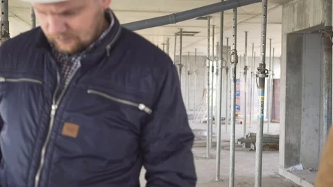 Engineers talk about building work and walk away. Stock Footage 72359070