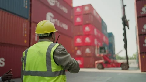 Engineers talking on walkie talkie, control loading container on delivery truck. Stock Footage 264759833