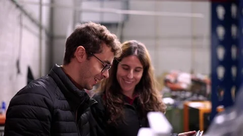 Engineers talking while checking material in stock room Stock Footage 261223997