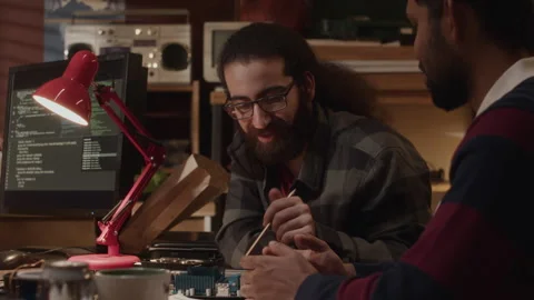 Engineers Talking while Examining Motherboard Stock Footage 263313381
