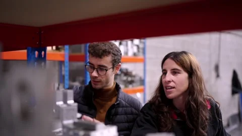 Engineers talking while revising material in stock room Stock Footage 260510188