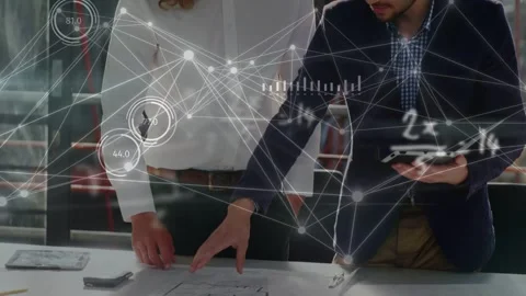 Engineers tapping tablet and leaning over plans, reviewing while data HUD Stock Footage 334768307