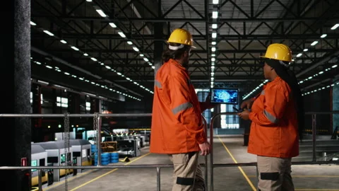 Engineers team analyzes AI brain interface inside heavy industry factory Stock Footage 330089933