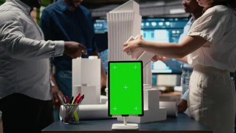 Engineers team share master plan ideas next to chroma key display Stock Footage 316643290