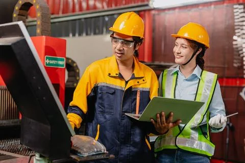 Engineers teamwork, Engineer man and woman team working together in metal w.. Stock Photos